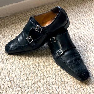 Black double-monk strap wingtip shoes